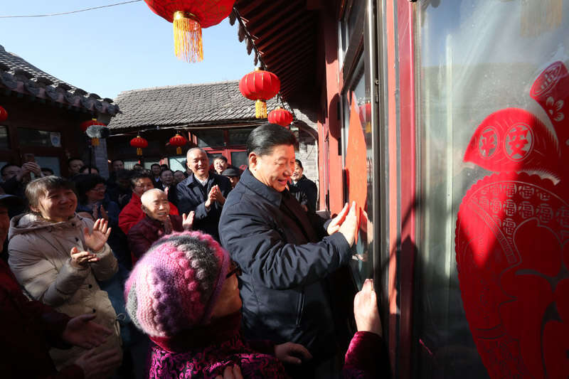 2019年2月1日上午，習(xí)近平在北京前門東區(qū)草廠四條胡同32號(hào)院，高興地拿起一幅“福”字，親自貼到門上，給這里的老街坊們拜年。新華社記者 鞠鵬 攝